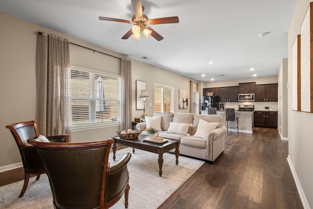 living area featuring recessed lighting, baseboards, ceiling fan, and dark wood-style flooring