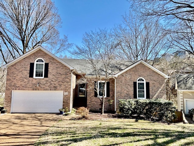 view of front of house featuring a front lawn, an attached garage, brick siding, and driveway