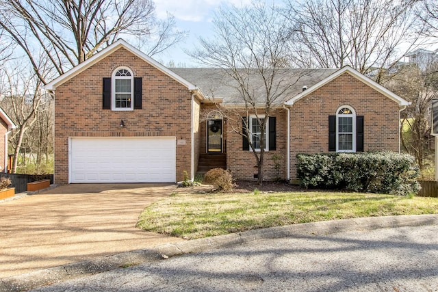 view of front of property with brick siding, driveway, and a garage