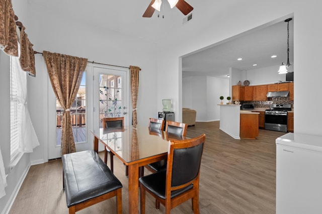 dining room with wood finished floors, visible vents, and a wealth of natural light