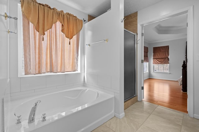 full bath with tile patterned flooring, a shower stall, a bath, and ornamental molding