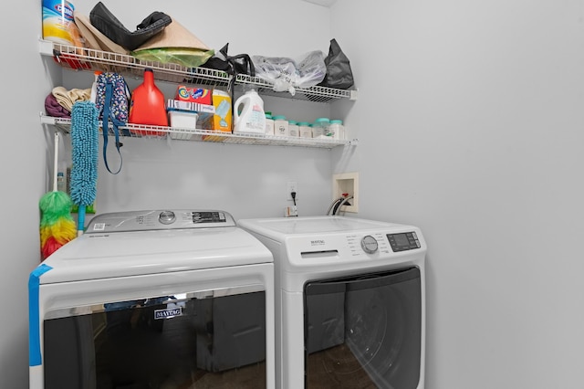 laundry room with washing machine and clothes dryer and laundry area