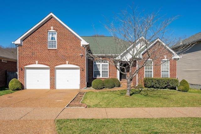 traditional home featuring a front yard, a garage, brick siding, and driveway