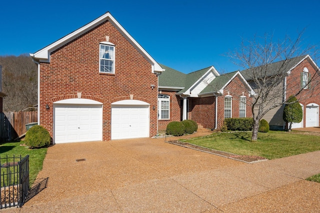 traditional-style house featuring a front yard, brick siding, driveway, and fence