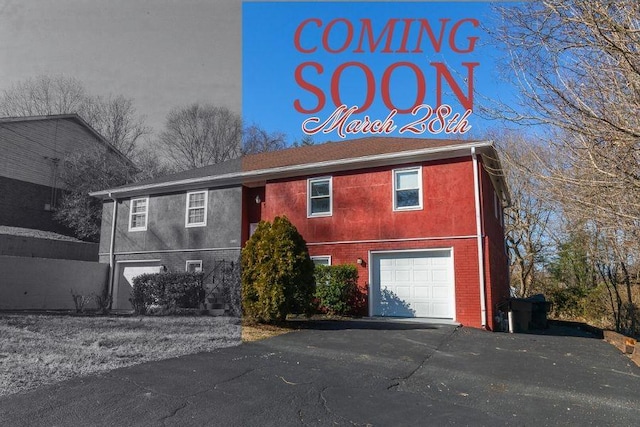 view of front of house with brick siding, stucco siding, aphalt driveway, and a garage