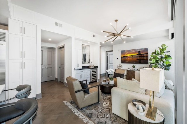 living area featuring recessed lighting, visible vents, wine cooler, and an inviting chandelier