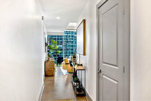 corridor featuring recessed lighting and baseboards