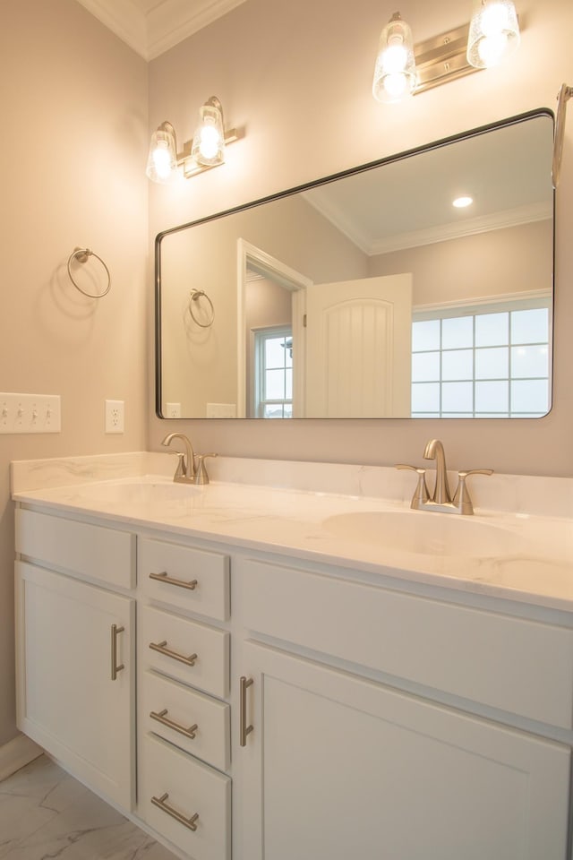 bathroom with a sink, marble finish floor, and ornamental molding