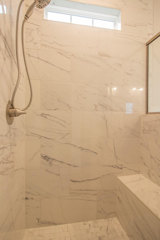 bathroom with a tile shower