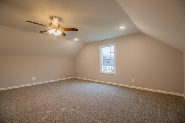 additional living space with lofted ceiling, recessed lighting, baseboards, and dark colored carpet