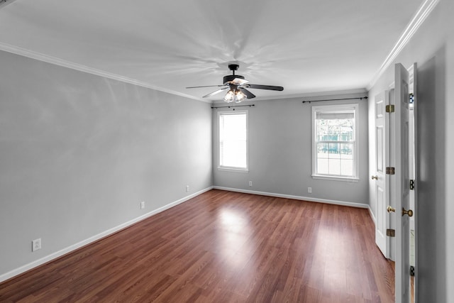 empty room with ornamental molding, ceiling fan, plenty of natural light, and wood finished floors