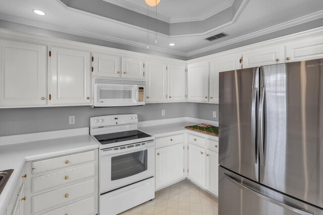 kitchen featuring visible vents, white cabinets, white appliances, crown molding, and a tray ceiling