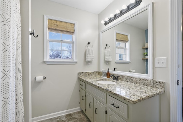 bathroom featuring vanity and baseboards