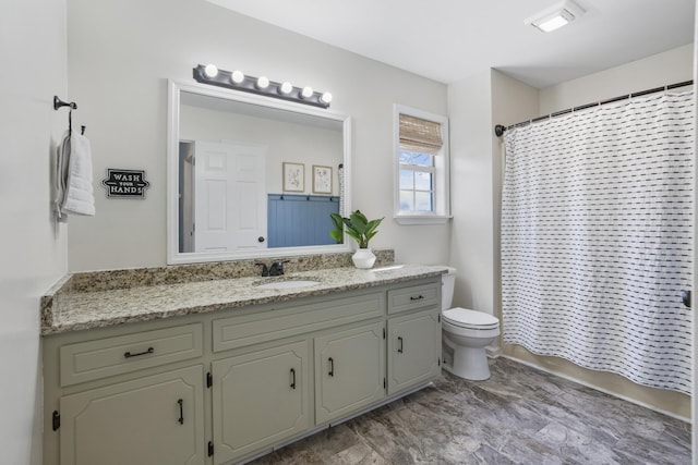 bathroom with shower / bathtub combination with curtain, toilet, and vanity