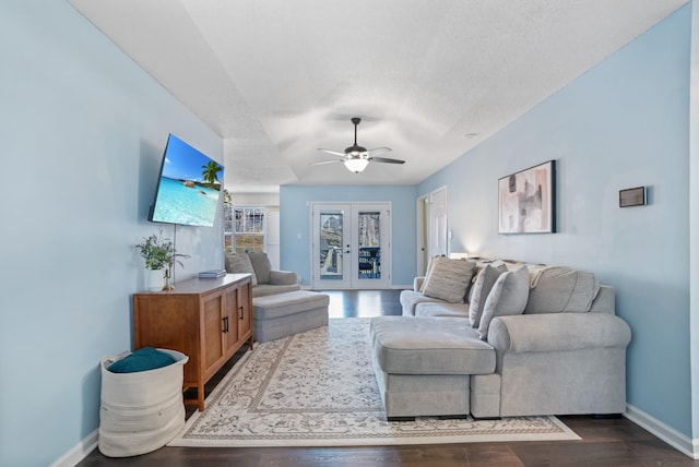 living room featuring dark wood finished floors, ceiling fan, french doors, and baseboards