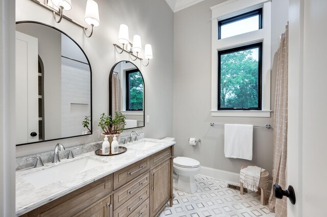 full bath featuring visible vents, toilet, baseboards, and a sink