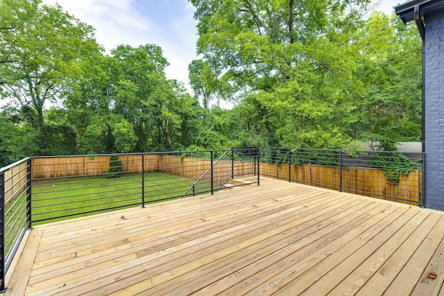 wooden terrace featuring a lawn