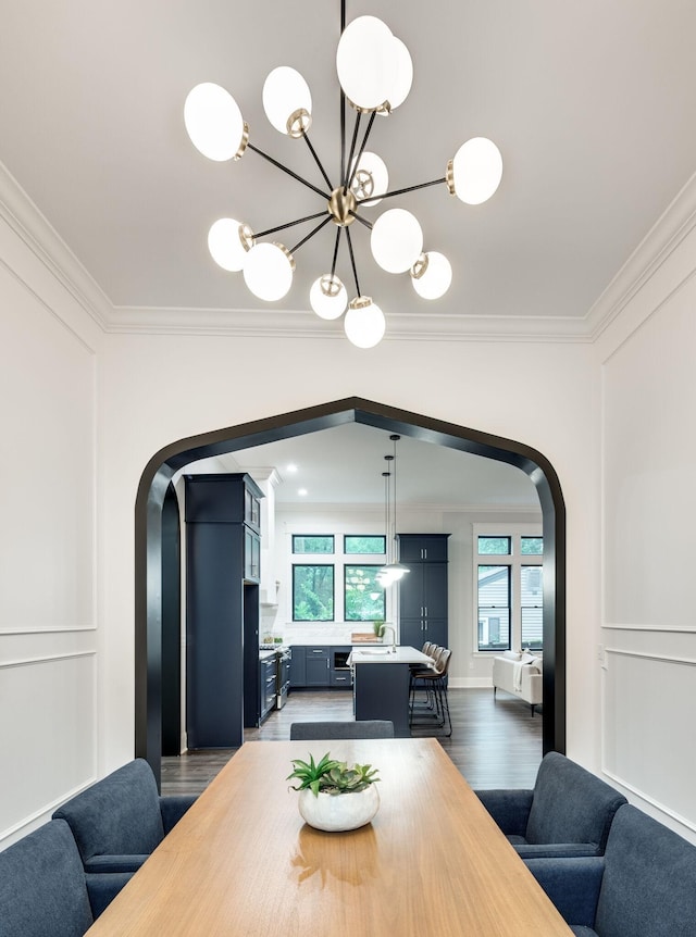 dining area with arched walkways, a decorative wall, crown molding, and dark wood-type flooring