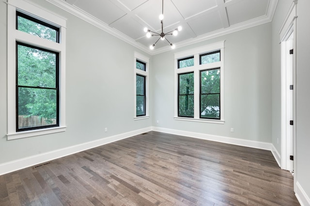 empty room with a wealth of natural light, visible vents, coffered ceiling, and baseboards