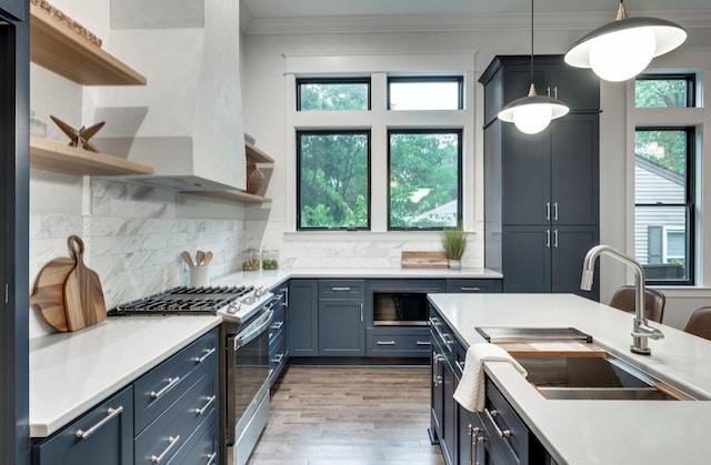 kitchen featuring open shelves, ornamental molding, gas stove, and a sink