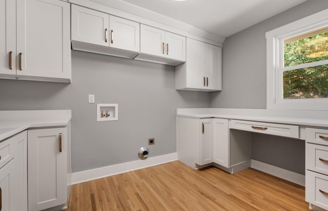 laundry room with electric dryer hookup, light wood-type flooring, cabinet space, baseboards, and hookup for a washing machine