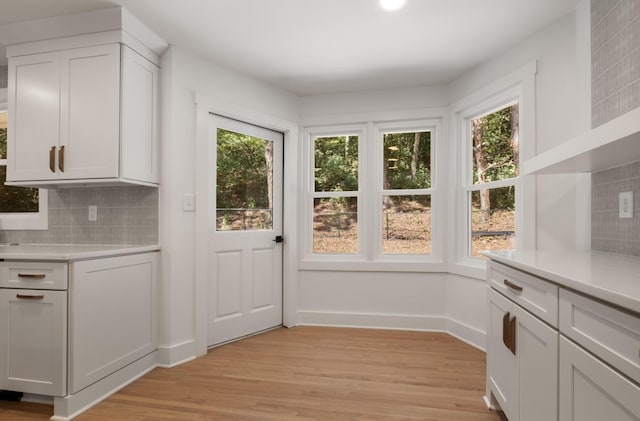 entryway with light wood-type flooring and baseboards