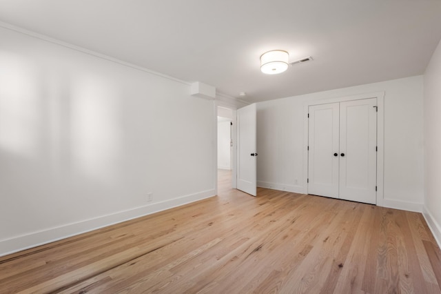 unfurnished bedroom featuring visible vents, baseboards, and light wood finished floors