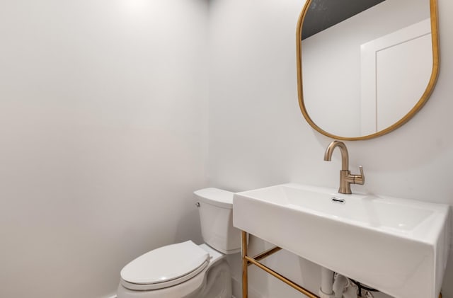 bathroom with toilet and a sink