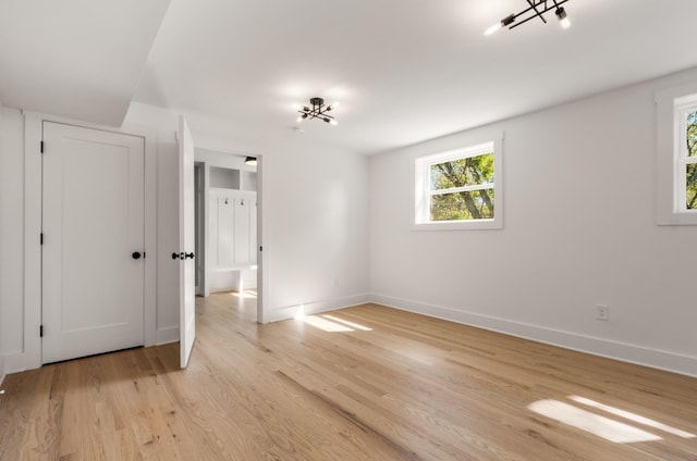 unfurnished bedroom featuring baseboards and light wood finished floors