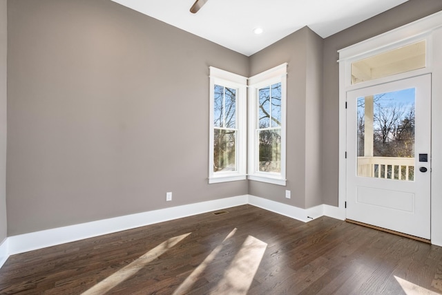 foyer with a wealth of natural light, recessed lighting, dark wood-type flooring, and baseboards