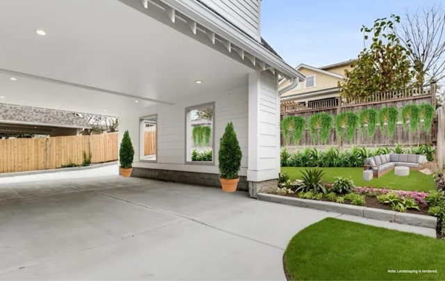 entrance to property featuring a lawn, outdoor lounge area, and fence