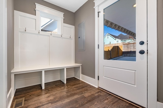 mudroom with electric panel, dark wood-style floors, visible vents, and baseboards