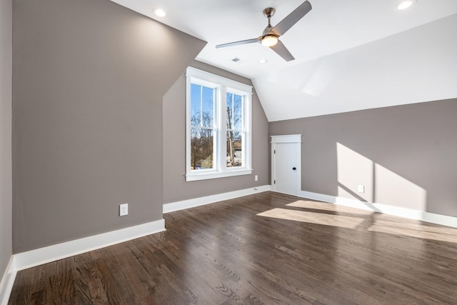 bonus room with visible vents, baseboards, ceiling fan, vaulted ceiling, and dark wood-type flooring