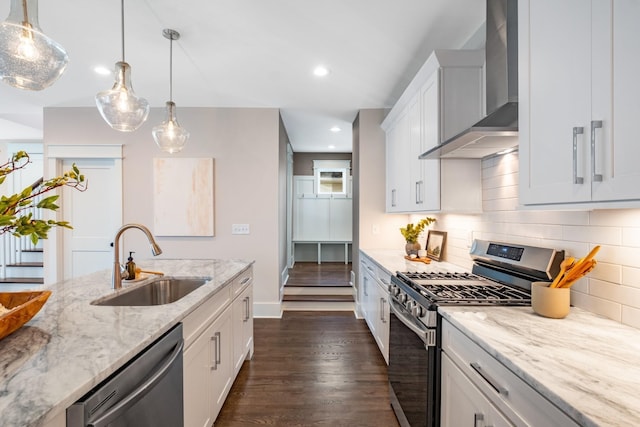 kitchen featuring backsplash, dark wood-type flooring, stainless steel appliances, wall chimney exhaust hood, and a sink