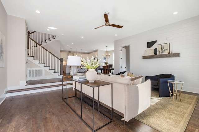 living room featuring visible vents, stairway, recessed lighting, ceiling fan with notable chandelier, and wood finished floors