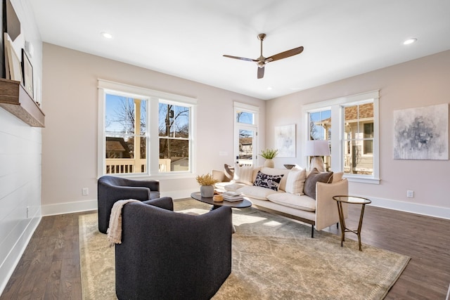 living area with recessed lighting, baseboards, a ceiling fan, and dark wood-style flooring