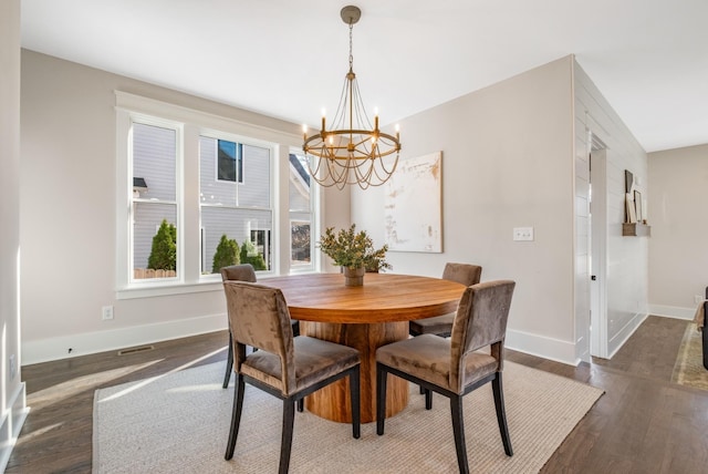 dining space featuring visible vents, baseboards, a notable chandelier, and dark wood-style flooring