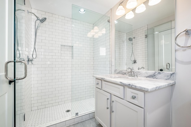 bathroom featuring vanity and a shower stall