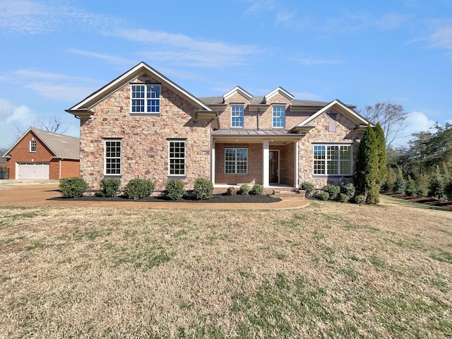 view of front of property featuring a standing seam roof and a front yard