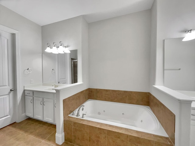 bathroom featuring tile patterned floors, a tub with jets, vanity, and a shower