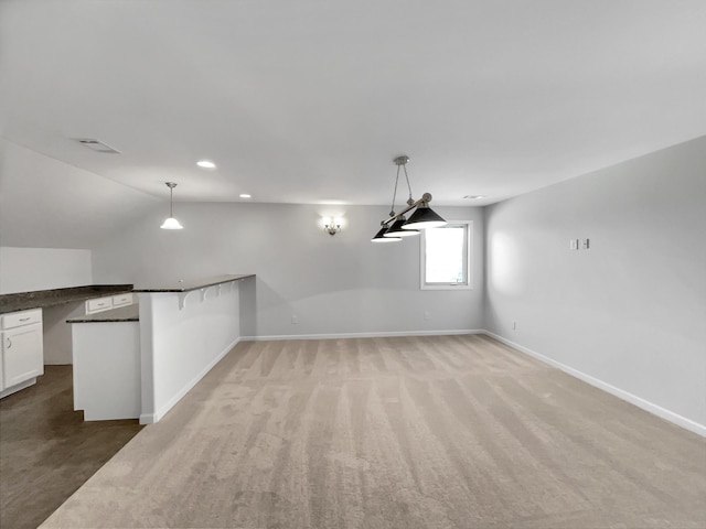 unfurnished dining area with recessed lighting, visible vents, baseboards, and vaulted ceiling