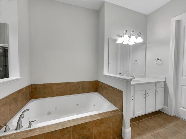 full bathroom with tile patterned flooring, vanity, and a tub with jets