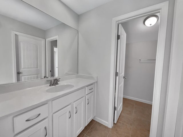 bathroom featuring vanity, tile patterned floors, and baseboards