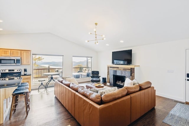 living area featuring lofted ceiling, recessed lighting, a fireplace, dark wood-type flooring, and a chandelier