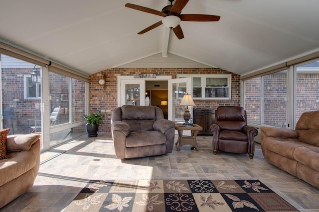 interior space featuring a ceiling fan, brick wall, and vaulted ceiling with beams