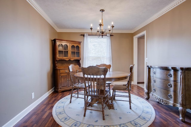 dining room featuring dark wood finished floors, a notable chandelier, baseboards, and ornamental molding