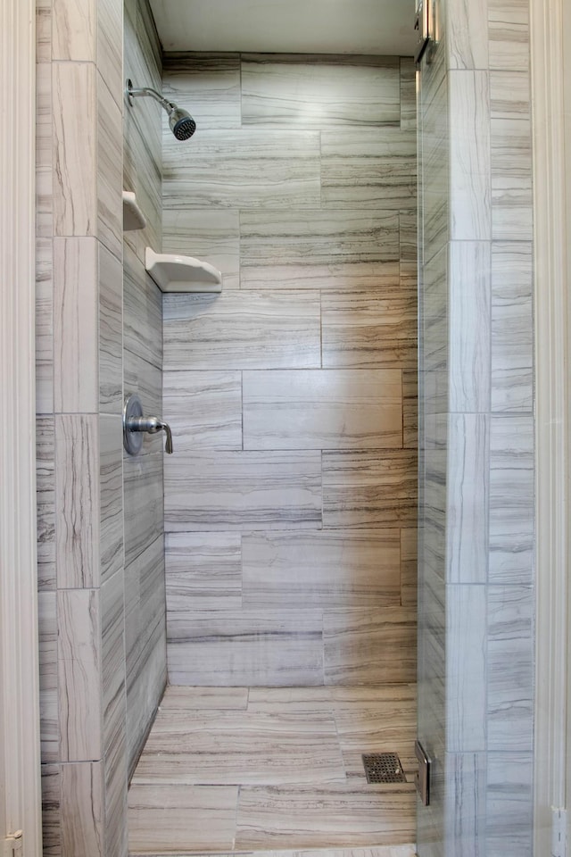 bathroom with a tile shower