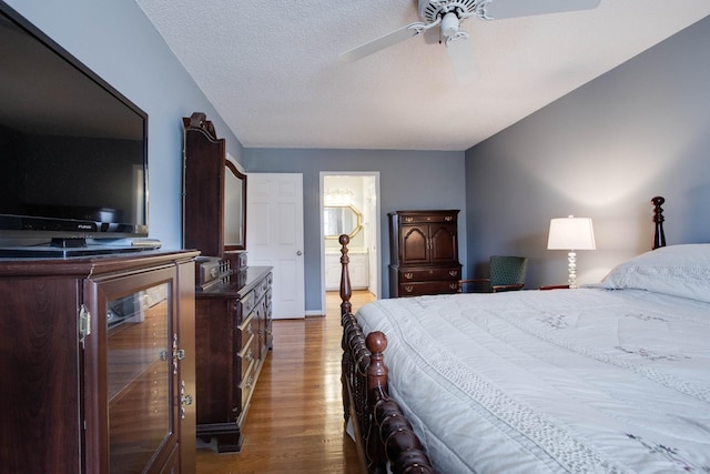 bedroom featuring ceiling fan, a textured ceiling, and wood finished floors