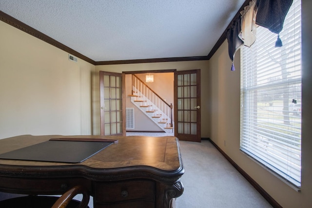 office with visible vents, carpet floors, a textured ceiling, and ornamental molding