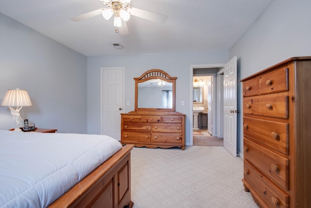 bedroom featuring visible vents, ensuite bath, and ceiling fan